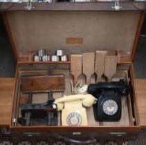 A German vintage leather suitcase, labelled for Moritz Muller, Leipzig, to/w two vintage telephones,