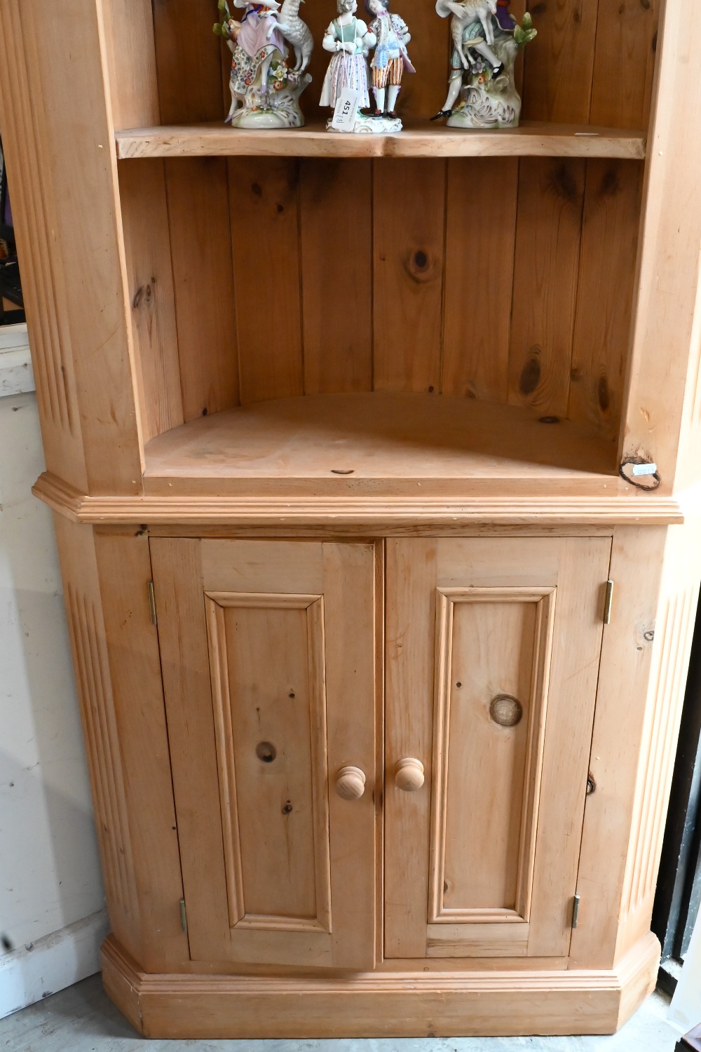 A waxed pine corner cabinet with open shelves above two panelled doors - Image 2 of 3