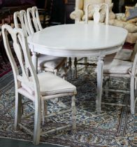 A distressed off-white painted double d-end dining table and extension leaf, to/with a set of six