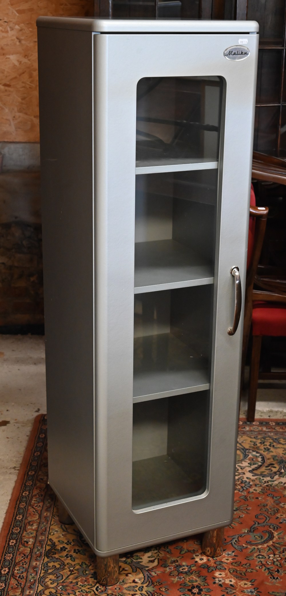 A modern grey painted 'Malibu' cupboard with glazed door, cylindrical chrome feet and three