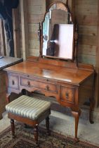 A walnut mirror-backed dressing table with brush slide and three drawers on cabriole supports, 118