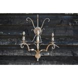 A large scrolling metal three-sconce wall light, 65 cm high