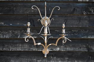 A large scrolling metal three-sconce wall light, 65 cm high