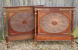 A walnut and bergere double bed (head and footboard, missing rails) with double-caned oval panels,