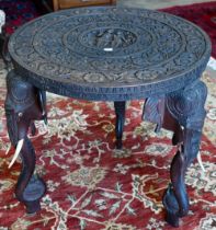 An early 20th century carved hardwood Indian 'elephant' side table (A/F) 60 cm dia. x 62 cm high