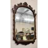 Large fret-cut mahogany framed mirror with arched and bevelled plate in parcel gilt frame 105 x 70cm