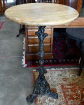 A circular hardwood poseur bar/bistro table on ornate cast iron base, 68 cm dia. x 110 cm high