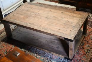 A rustic stained hardwood two-tier coffee table, 120 x 70 x 40 cm h