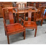 A set of eight Chinese rosewood dining chairs, the backs carved with Shou symbols and panelled seats