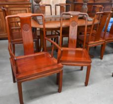 A set of eight Chinese rosewood dining chairs, the backs carved with Shou symbols and panelled seats