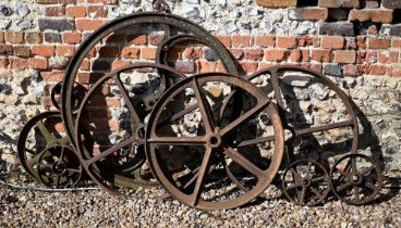 Assorted vintage cast iron spoked carriage/cart wheels etc in varying sizes, the largest 96 cm