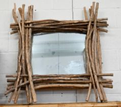 A wall mirror in layered driftwood frame, 100 x 100 cm