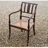 A 19th century mahogany elbow chair with caned seat