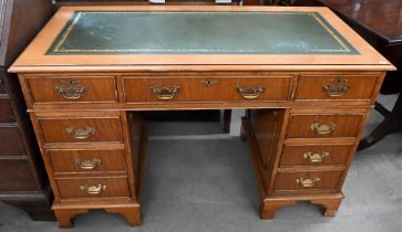 A light oak veneered twin pedestal desk with gilt tooled green leather top, 122 x 60 x 76 cm high