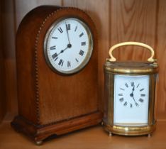 An oval brass carriage clock 16 cm high overall to/w an inlaid mahogany mantel clock with French