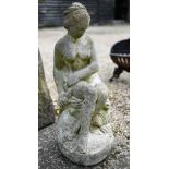 A weathered cast stone garden figure of a classical seated nude woman, 60 cm h