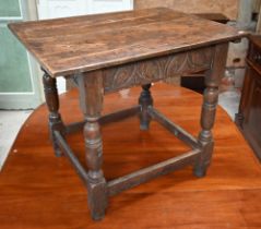 A 17th century oak rectangular side table with lunette carved frieze, turned supports united by