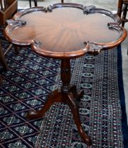 A mahogany butterfly design side table with lobed top on tripod base, 60 cm dia. x 70 cm h