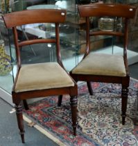 A set of six Victorian mahogany bar back dining chairs, with fabric seat pads, raised on turned