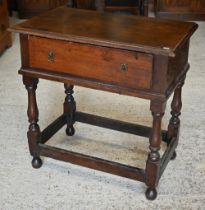 An antique oak side table with single frieze drawer on turned supports united by stretchers, 78 x 46