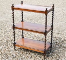 A Victorian rosewood three-tier whatnot with barley twist pillars, short turned legs and brass