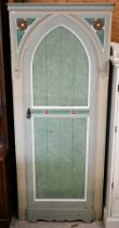 A painted and Tudor Rose carved wardrobe with Gothic arch panelled door, shelved interior,