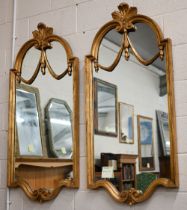 A pair of large wall mirrors with decorative carved and moulded giltwood frames, 130 x 61 cm