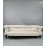 A traditional button back upholstered sofa circa 1900,200 cm x 78 cm x 66 cm h, missing one  castor