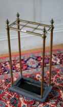 An antique six division brass stick-stand with cast iron base, 32 cm x 18 cm x 64 cm h