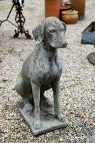 A large composite stone seated dog statue, 73 cm h