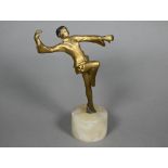 An Art Deco gilt-patinated bronzed figure of a dancing girl, unsigned, 12 cm high