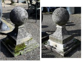 A large pair of antique weathered cast stone ball finial pier caps, raised on tapering form square