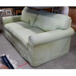 A two seater scroll arm sofa, with patterned green fabric loose covers, 190 x 95 x 80 cm high