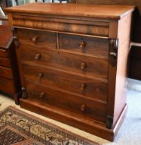 A large Victorian country house chest of drawers, the full width cavetto drawer over two short and