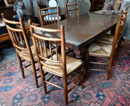 An oak draw-leaf refectory dining table with cleated planked top on turned supports with stretchers,