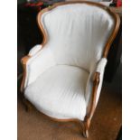 A French beech-framed fauteuil armchair, upholstered and covered in cream brocade, on cabriole
