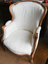 A French beech-framed fauteuil armchair, upholstered and covered in cream brocade, on cabriole