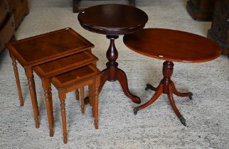 Yew veneered nest of three occasional tables to/w an oval occasional table and a circular tripod