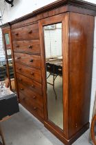 A 19th century mahogany inverted breakfront compactum wardrobe with seven central drawers flanked by