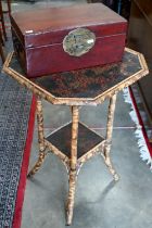 A Victorian octagonal bamboo occasional table with Japanned top panel and under tier to/w