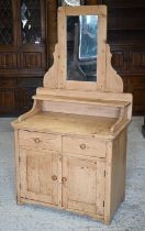 A rustic pine mirror-backed dressing chest with two drawers over panelled cupboards, 84 x 48 x 160