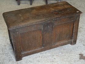 A small 17th century panelled oak coffer, with hinged top and jointed construction, 86 x 40 x 48