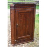 A Georgian oak hanging corner cupboard a/f, 80 x 120 cm