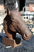 A weathered cast iron horse head garden feature, 44 cm h