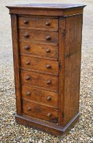 A Victorian oak secretaire Wellington chest of drawers, with original turned fittings raised on a