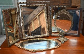 An oval wall mirror in decorative gilt frame, gilt framed triptych mirror, pierced brass dressing