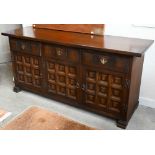 A 'Younger' Toledo oak Spanish style sideboard with three frieze drawers above panelled doors, 157cm