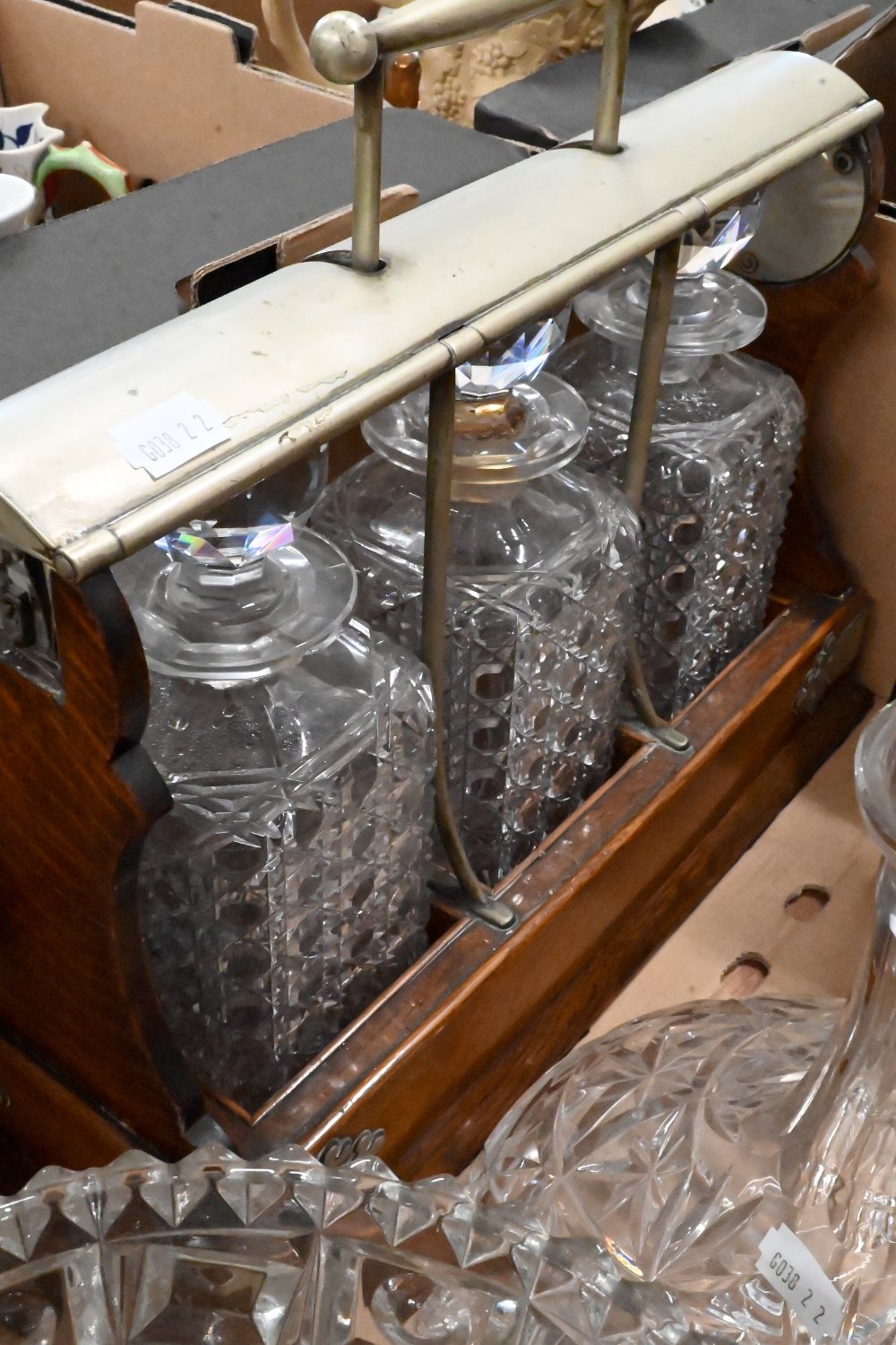 An oak tantalus with three square cut decanters (lock a/f), to/w three other decanters and a pressed - Image 2 of 2
