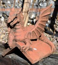 A small cast terracotta recumbent dragon ridge tile, 35 cm h