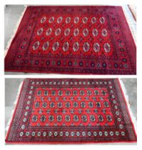 A Turkoman design rug with repeat gul design on red ground 190 x 124 cm to/w similar machine made